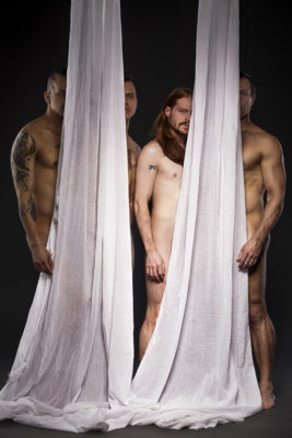 nude men obscured by hanging sheets