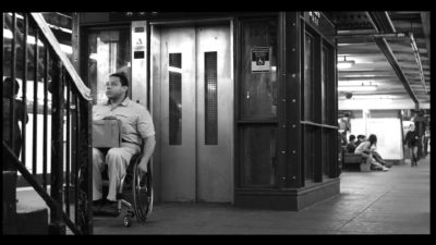 man in wheel chair outside a broken MTA elevator