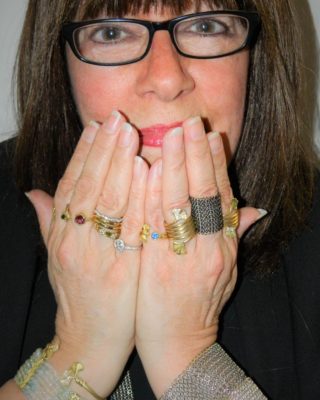Alison Nagasue wearing examples of her jewelry on her wrists and fingers
