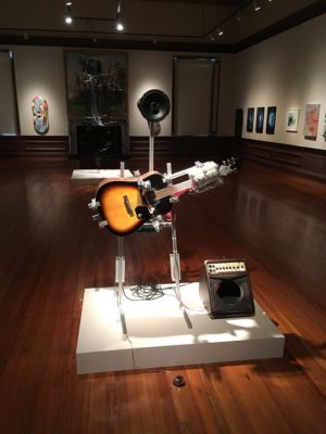 guitar playing robot artwork titled This Machine Kills Fascists