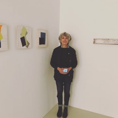 Jean Feinberg with her artwork at Beth Urdang Gallery