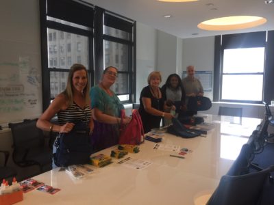 staff members working on backpacks for Operation Backpack