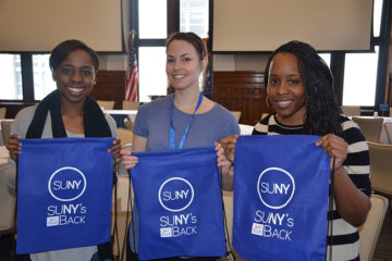 women holding SUNY's Got Your Back backpacks