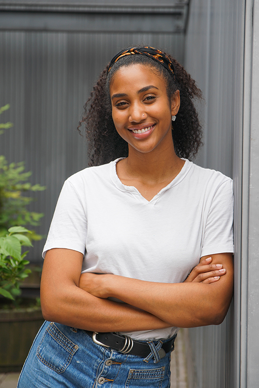 young smiling african-american woman in white t shirt