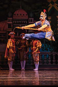 Kyle Davis on stage dancing in The Nutcracker in Chinese costume