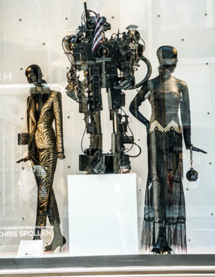 mannequin in metallic suitmannequin in sequin dresses with metal robot sculptures