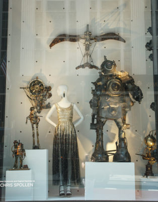 mannequin in sequined dress and metal robot sculptures