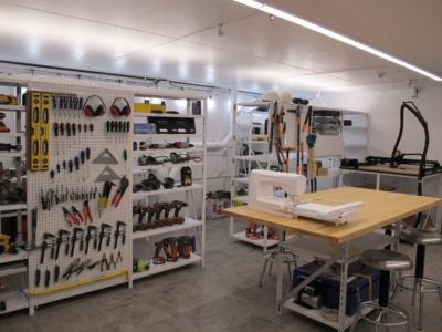 room with sewing machine, levels, power drills, and other tools