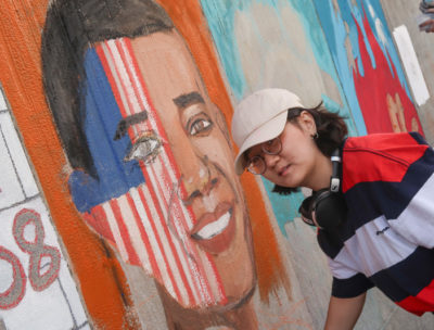 Student painting mural of President Obama
