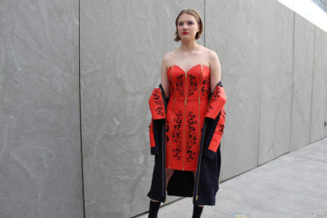 model wearing dress of dre orange material with cut outs