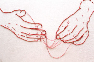 embroidery of two hands with loose threads strung between them
