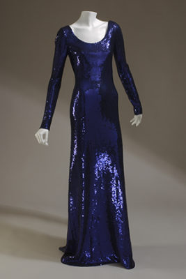 Deep blue-violet sequinned jersey evening shift; floor length pullover dress with deep scoop neck; long narrow sleeves; slightly flared; machine-applied sequins