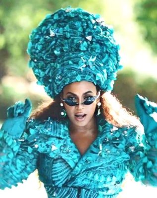 Beyonce in a blue jacket and hat