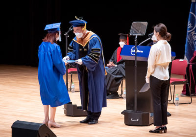Graduate receiving a degree on stage