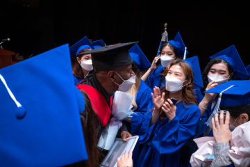 Korean graduates in blue caps and gowns