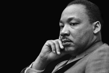 Portrait of Martin Luther King Jr. holding his chin.
