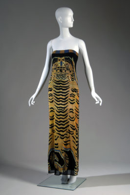 Long, strapless "Tibetan Tiger" column dress with large-scale design printed in shades of orange, gray and black on nylon net, with black jersey underdress