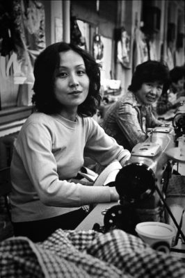 Asian American women sitting at sewing machines