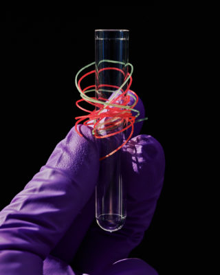 test tube wrapped in pink and green fibers