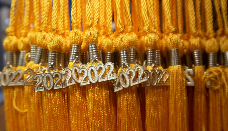 a group of yellow 2022 tassels