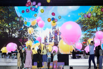 students on stage with digital and real balloons celebrate SUNY Korea's anniversary