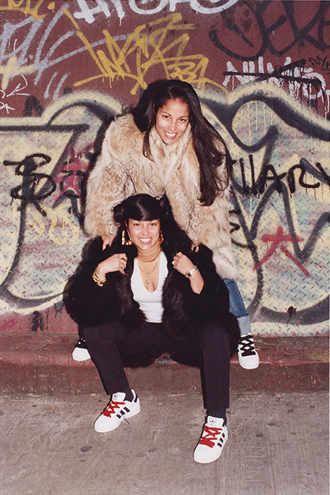 two women standing in front of graffiti; photo by Jamel Shabazz
