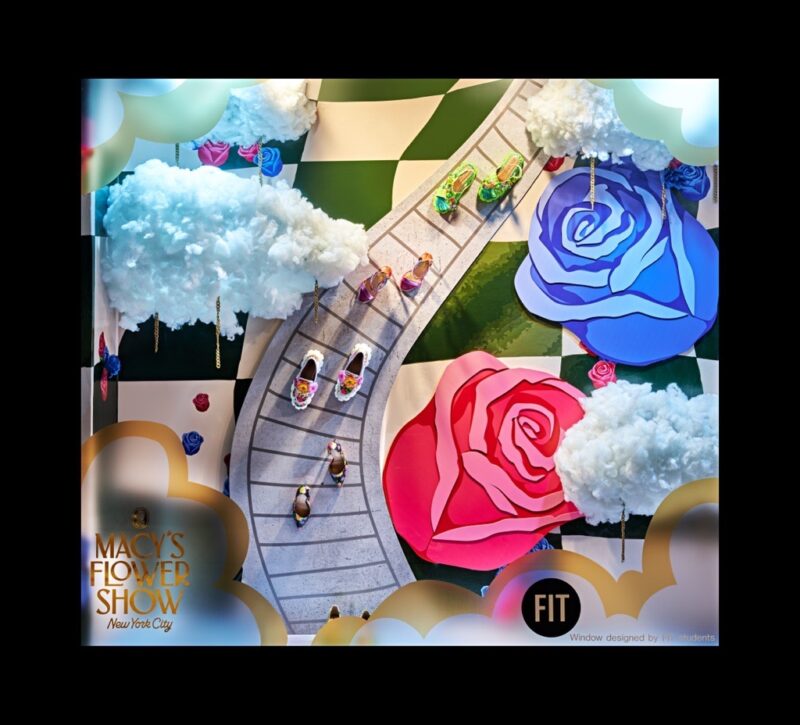 photo of Macy's Flower Show window by FIT students with pairs of shoes on an illustrated path with illustrated flowers surrounding it