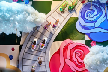 photo of Macy's Flower Show window by FIT students with pairs of shoes on an illustrated path with illustrated flowers surrounding it
