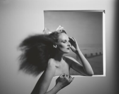 black and white photo of Grace Coddington with her long hair blowing behind her