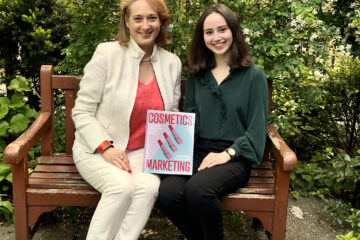 Delphine Horvath and Lindsay Karchin hold their book on a bench