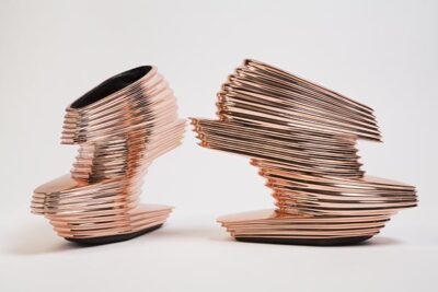 pair of copper colored architectural-looking high heeled shoes