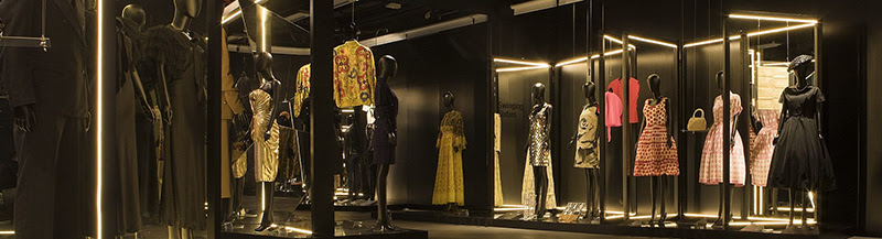 installation view of an exhibition of fashion mannequins