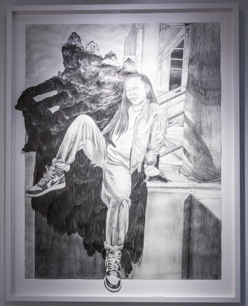 graphite portrait of a girl sitting on a stoop with shadows of a buddha repeated behind her