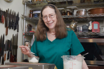 Rose Berenbaum in her kitchen measuring flour