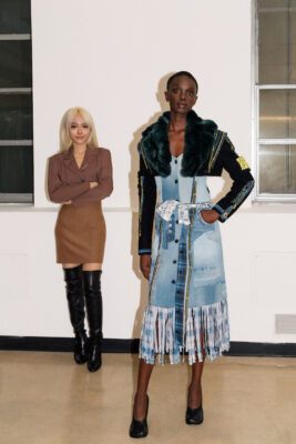 Hemera Luo stands with a model wearing her garment