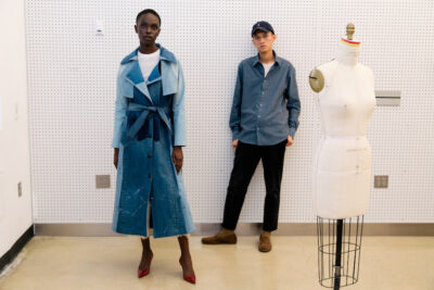 Nuo Cheng, Fashion Design '24, stands with a model wearing her garment