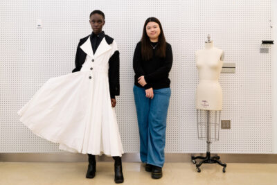 Siew Xin Tian, Fashion Design BFA '24, stands with a model wearing her garment