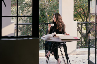 Grace Chen holding a tea cup at a table outdoors
