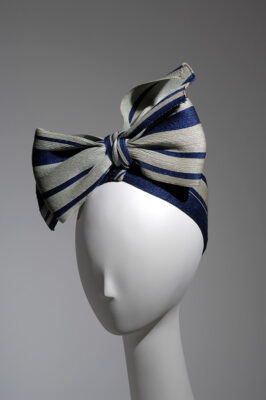 Pale green and navy striped straw turban variation tied in large CF bow