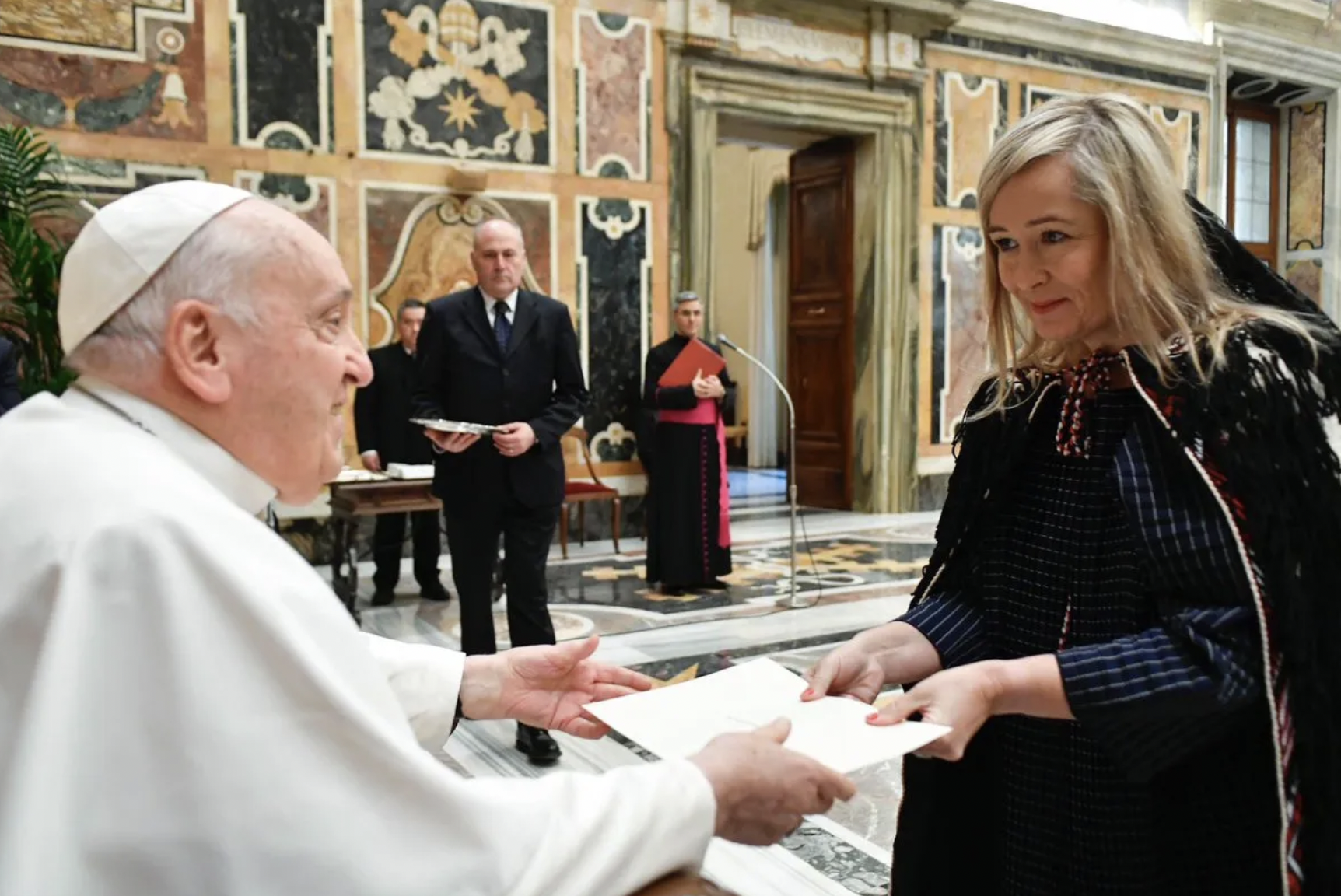 Tara Morton accepting a piece of paper from Pope Francis at the Vatican 