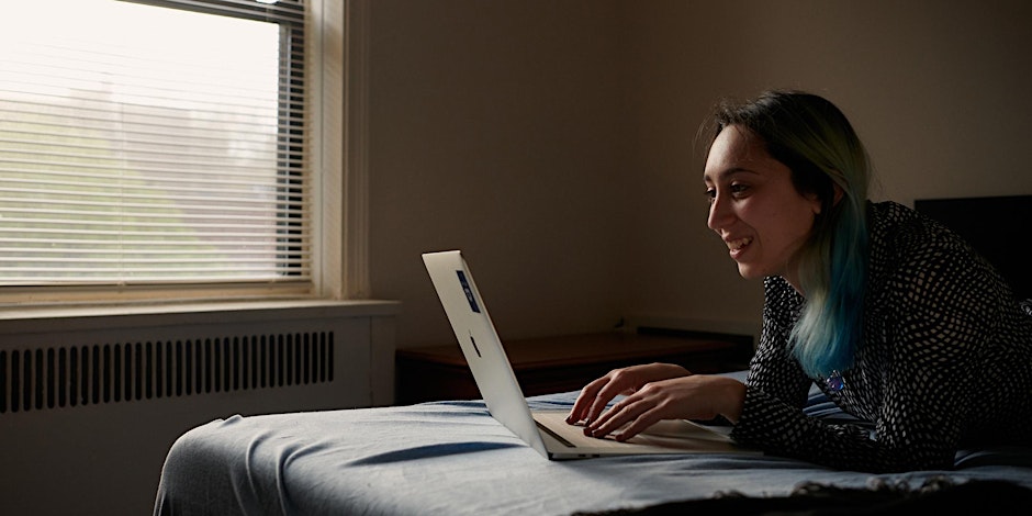 woman on her bed using a laptop
