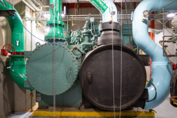 Two cylindrical containers with green pipes coming out of them