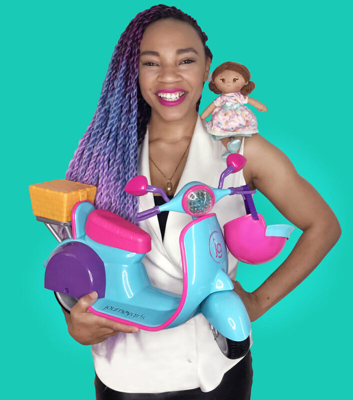 Azhell Wade stands with a toy scooter in her hands and a doll on her shoulder