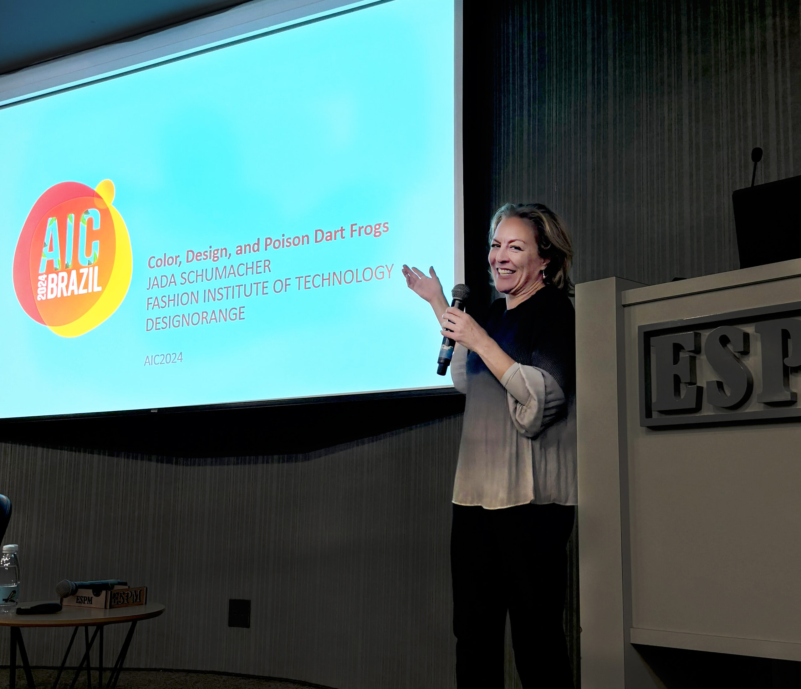 Jada Schumacher points to a screen during her presentation at a conference