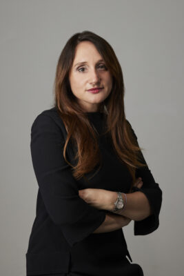 Erica Moretti sitting with hands folded in front of her