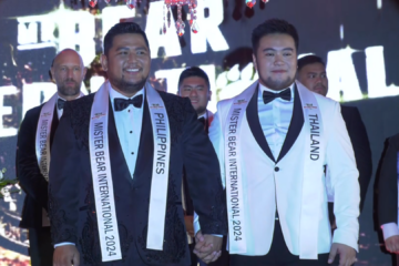 two men with pageant sashes around their necks