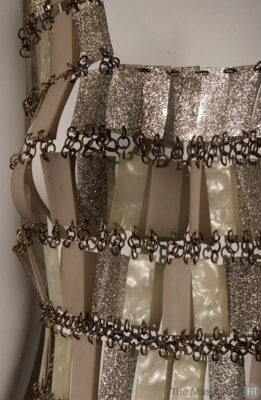 closeup of a dress on a mannequin with long, silver, rectangular glittery sequins