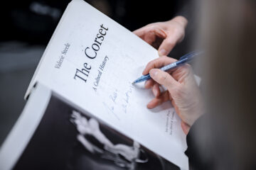 Author Valerie Steele signs the title page of her book The Corset.