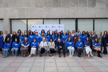 Baker Scholars, Baker Scholar Alumni, Dr. Joyce F. Brown, and Jay and Patty Baker pose for a photo on the patio of the FIT Dubinsky Center