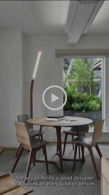 video still of a table with a floor lamp behind it